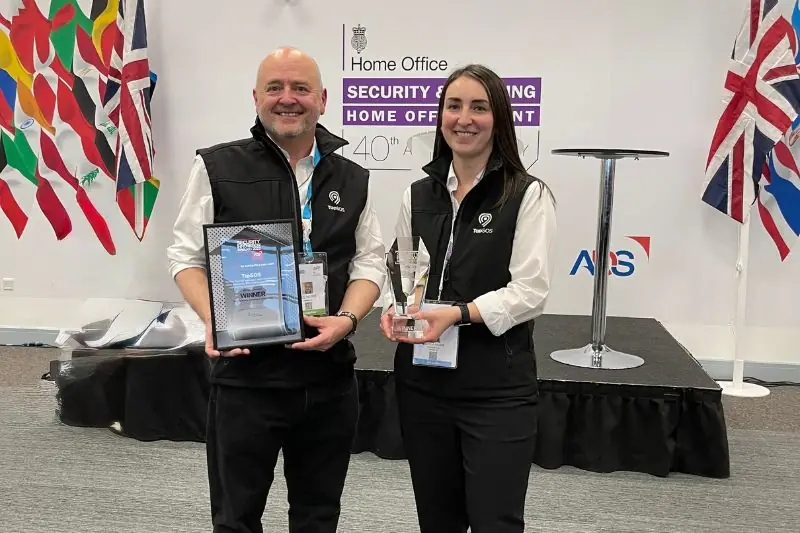 Two TapSOS team members holding awards at the Home Office Security and Policing event