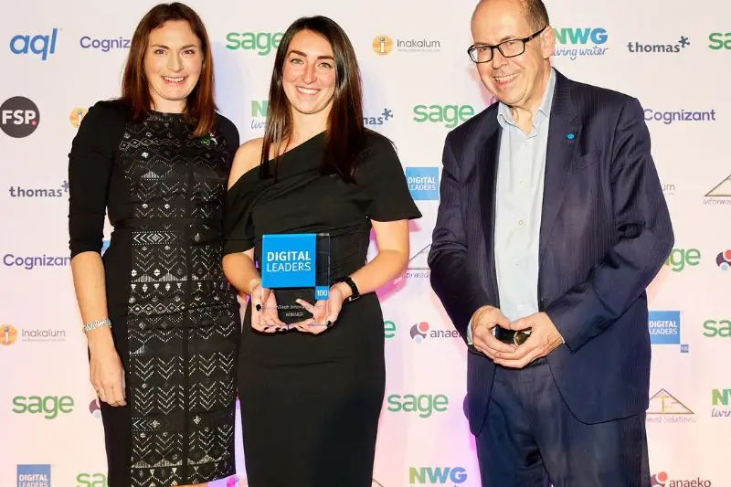 Three people at the Digital Leaders awards, one holding a Digital Leaders trophy