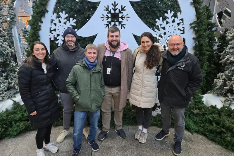 A group photo in front of a snowy winter display