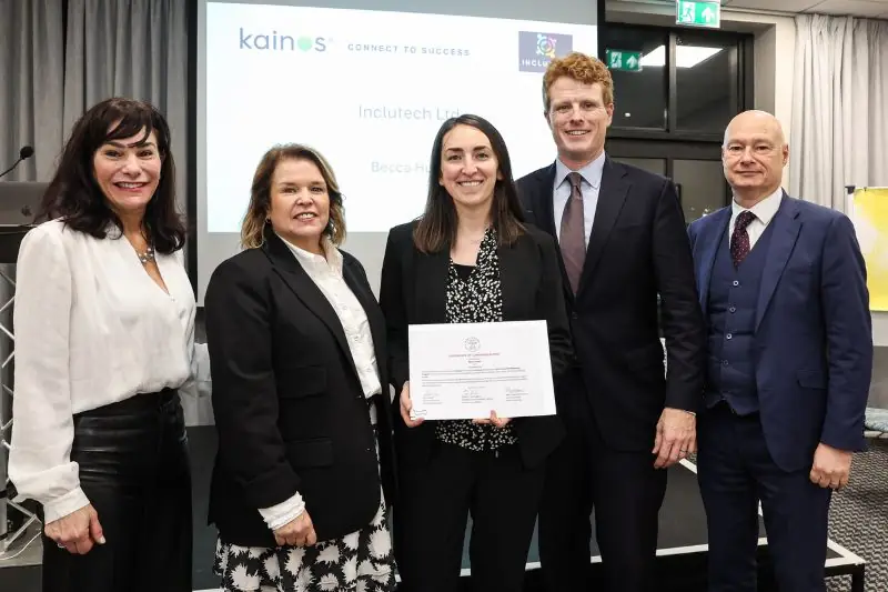 Five people at a Kainos event, one holding a certificate