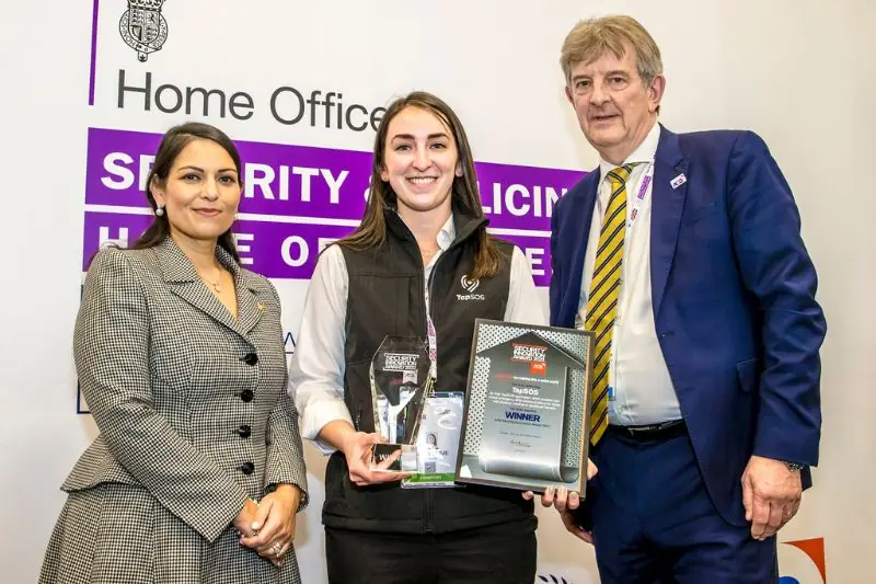 Accepting a winner's award in front of a Home Office Security and Policing banner